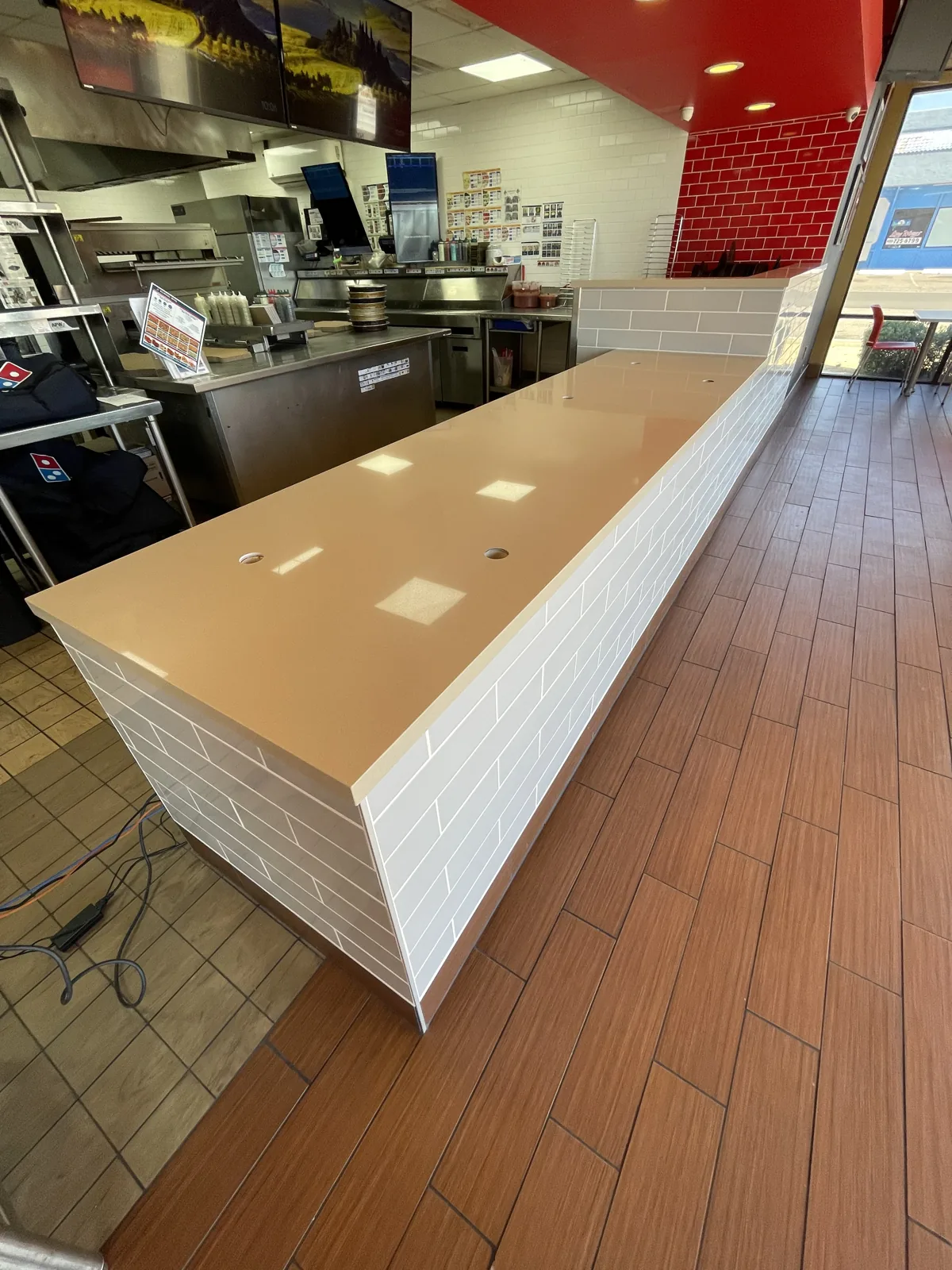 Commercial retail counter build-out with tiled front and durable flooring by Orange Cactus Remodeling