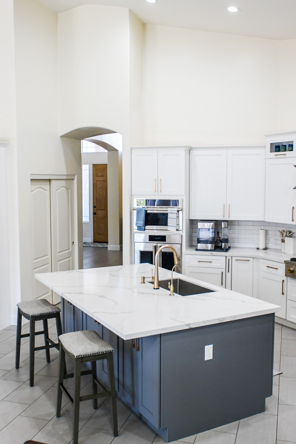 Kitchen with updated flooring, layered lighting, and clean cabinetry