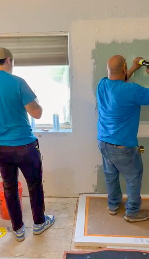 Bathroom remodel with floor-to-ceiling tile and a curbless walk-in shower