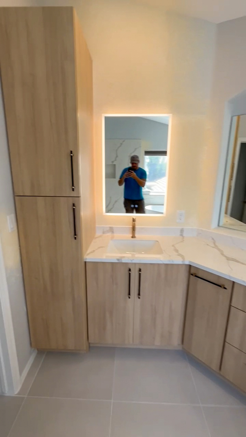 Compact guest bathroom with shaker vanity, quartz top, and framed mirror