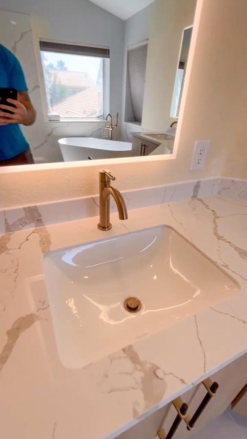 Bathroom with large-format tile, glass shower enclosure, and brushed nickel hardware