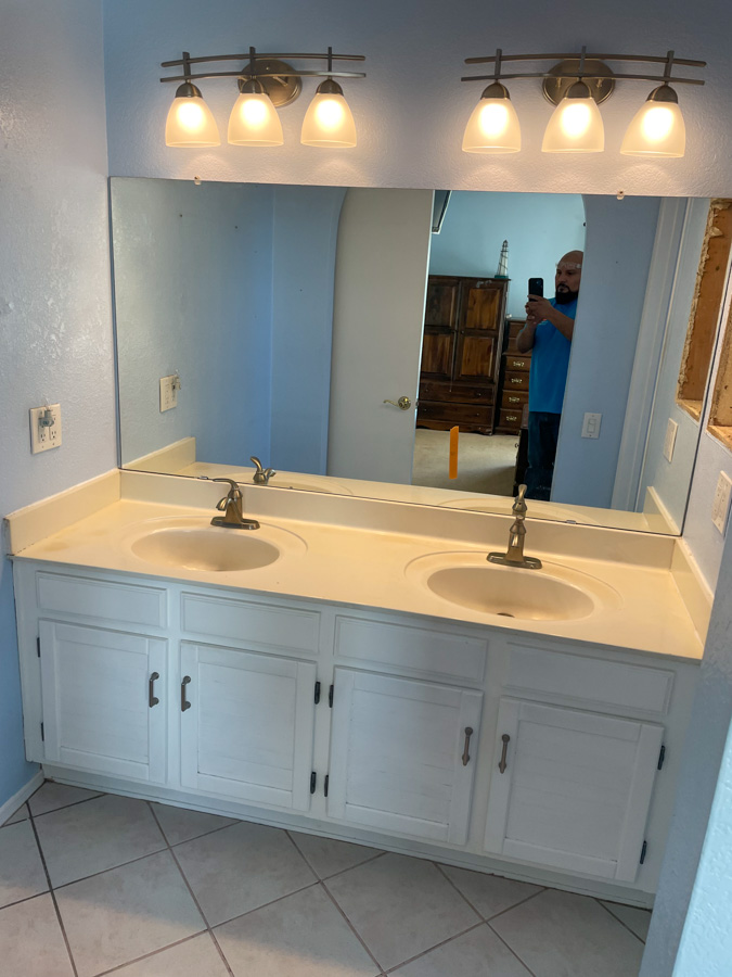 Remodeled kitchen with full-height tile backsplash, stainless appliances, and a large prep island